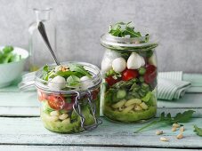 A layered green asparagus and pasta salad in jars