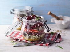 A layered fennel salad with salami in a jar