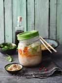 Miso soup with tofu and sesame seeds in a jar