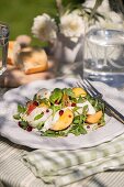 Fruity rocket salad with chicken and pomegranate seeds