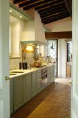 Country-house-style Mediterranean kitchen with terracotta floor tiles