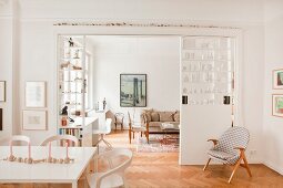 Collection of vases on partition shelving in open-plan interior