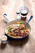 Penne pasta with beef ragout, Parmesan cheese and basil