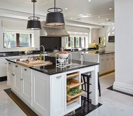 Large black and white kitchen with island counter and classic doors