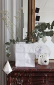 Branches in paper bag on mantelpiece