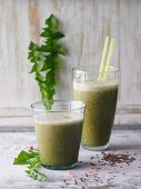 Green dandelion and cos lettuce smoothie with flax seeds and basil