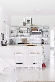 Open kitchen with white kitchenette, wall tiles and kitchen counter