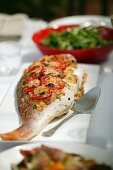 Baked Whole Fish with tomatoes & olives