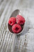 Raspberries on a silver spoon