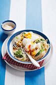 Spaghetti with poached eggs, Parmesan cheese and watercress