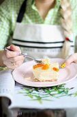 A woman eating cheesecake