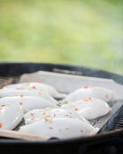 Squid filled with prawns and rice on a barbecue