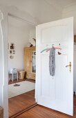 View into room in period apartment through open panelled door