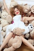 A young woman covered in teddy bears