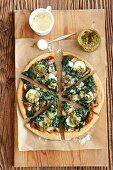 A vegetarian pizza topped with spinach, mushrooms and courgette