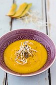 A smoothie bowl with mango and beansprouts