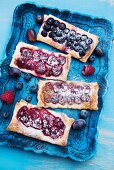 Various berry tarts on a tray