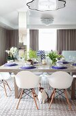 Spring dining table arrangement and plastic shell chairs in dining room