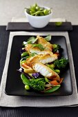 Bread cod fillet with Edamame beans, broccoli and red cabbage (Asia)