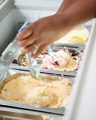 Various types of ice cream in containers in an ice cream parlour