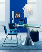 Modern furniture and blue wall in dining room in shades of blue
