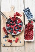 Various berries in cardboard planets and a frying pan