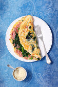 Omelette with ham, spinach, green peas and Pecorino cheese