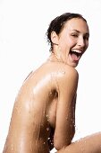 Topless woman under running shower