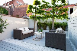 Lounge furniture in seating area of modern courtyard garden