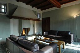 Lounge area with open fireplace in renovated country house