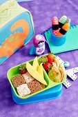 Break box with fresh fruit, sandwiches and pancakes