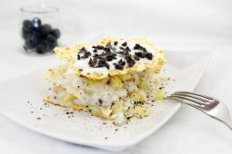 Millefeuille with fish, potatoes and black olives