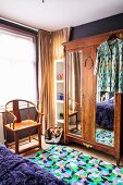 Old wooden chair and antique wardrobe in bedroom