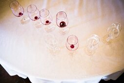 Clean and dirty wine glasses on a table, seen from above