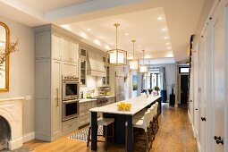 Dining table running into island counter in large kitchen