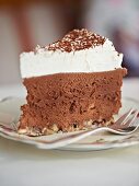A slice of chocolate mousse cake with almonds