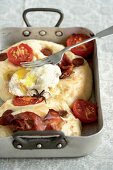 Focaccia with ham, sausage, tomatoes and a poached egg