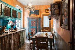 Dining table and ochre-yellow walls in vintage kitchen