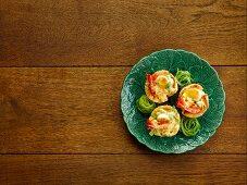 Crispy pastry shells filled with prawns and quail's eggs in saffron sauce