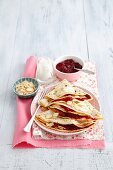 Pancakes with cherry jam, yoghurt and flaked almonds