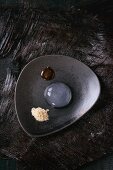 Raindrop cake with caramel sauce and fried flour on ceramic plate