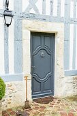 Elegant blue-grey front door of traditional half-timbered house