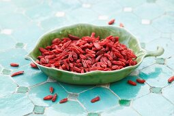 Dried goji berries in a leaf-shaped dish