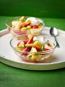 Fruit salad with limes and a dollop of cream