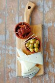 Triangles of Spanish cheese, stuffed olives and dried tomatoes (Spain)