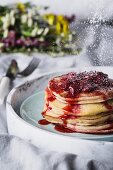 A stack of buttermilk pancakes with strawberry compote