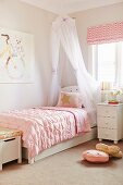 Romantic girl's room with canopy bed and pink duvet