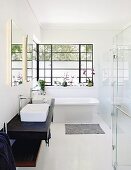 Free-standing bathtub and metal windows in elegant bathroom