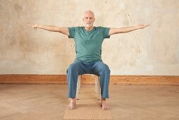 Breathing window (yoga) – Step 1: sitting, arms stretched to the side