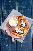 A sweet omelette with mascarpone and lime cream and blueberries